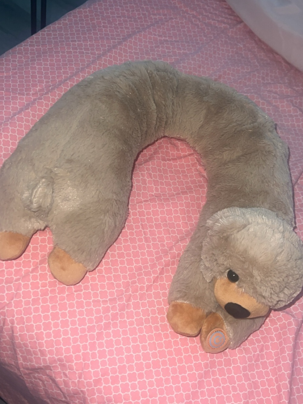 Beige neck pillow that vibrates